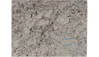 A close up of a white granite counter top.