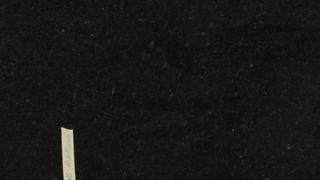 A close up of a piece of paper on a black background.