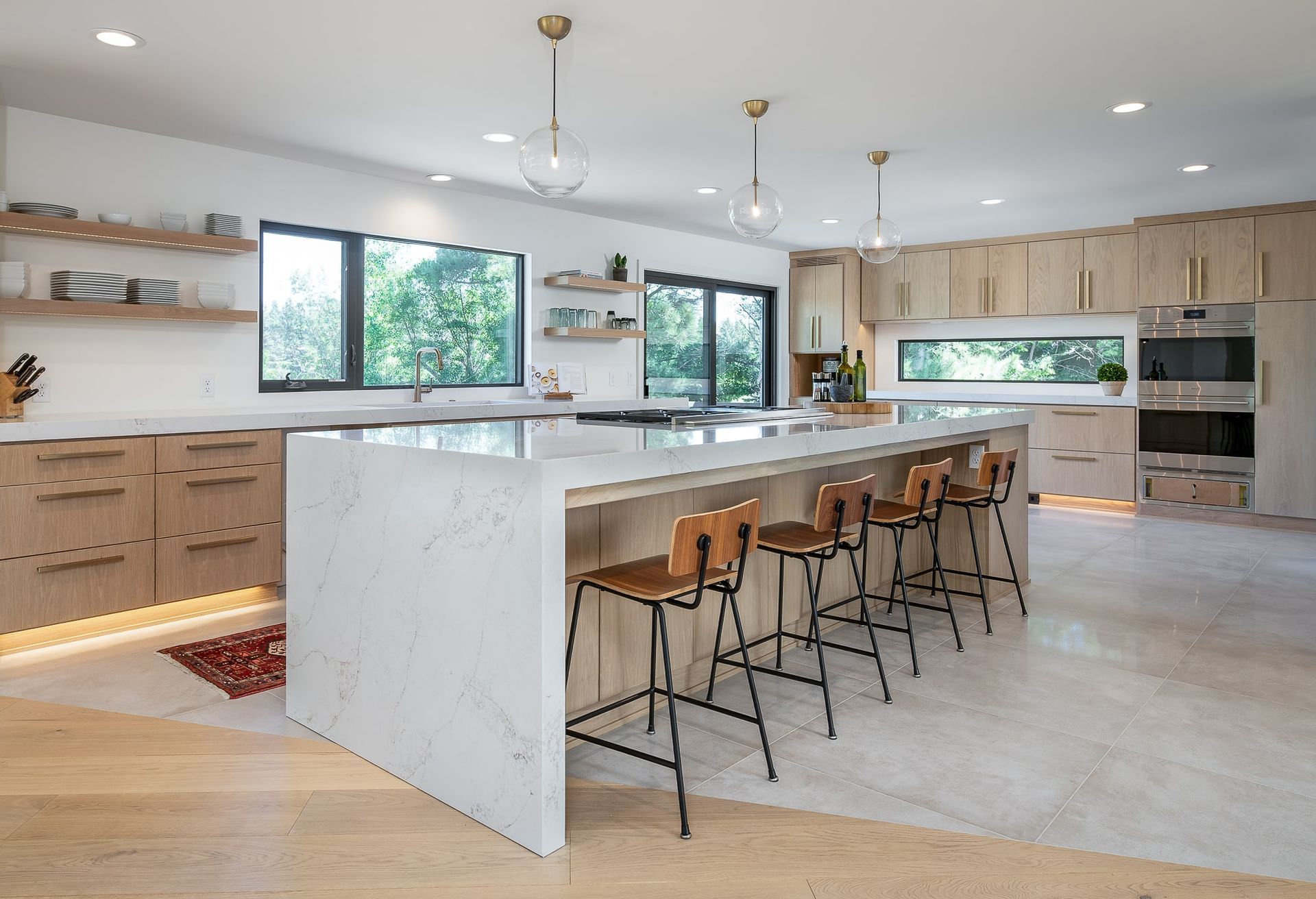 A large kitchen with a large island and stools.