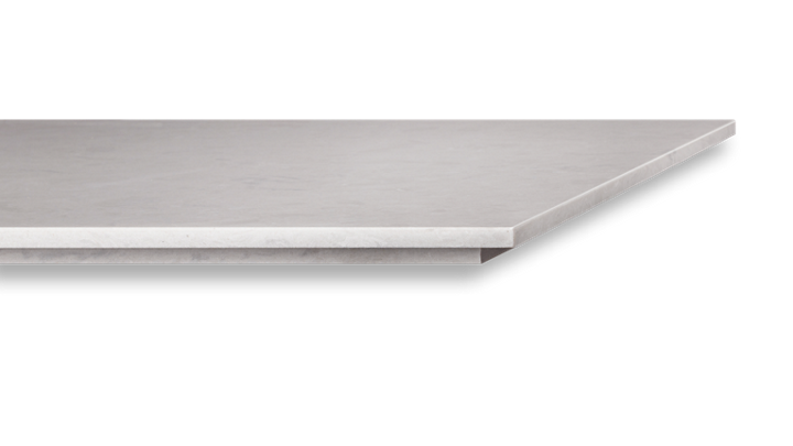 A close up of a stainless steel shelf on a white background.
