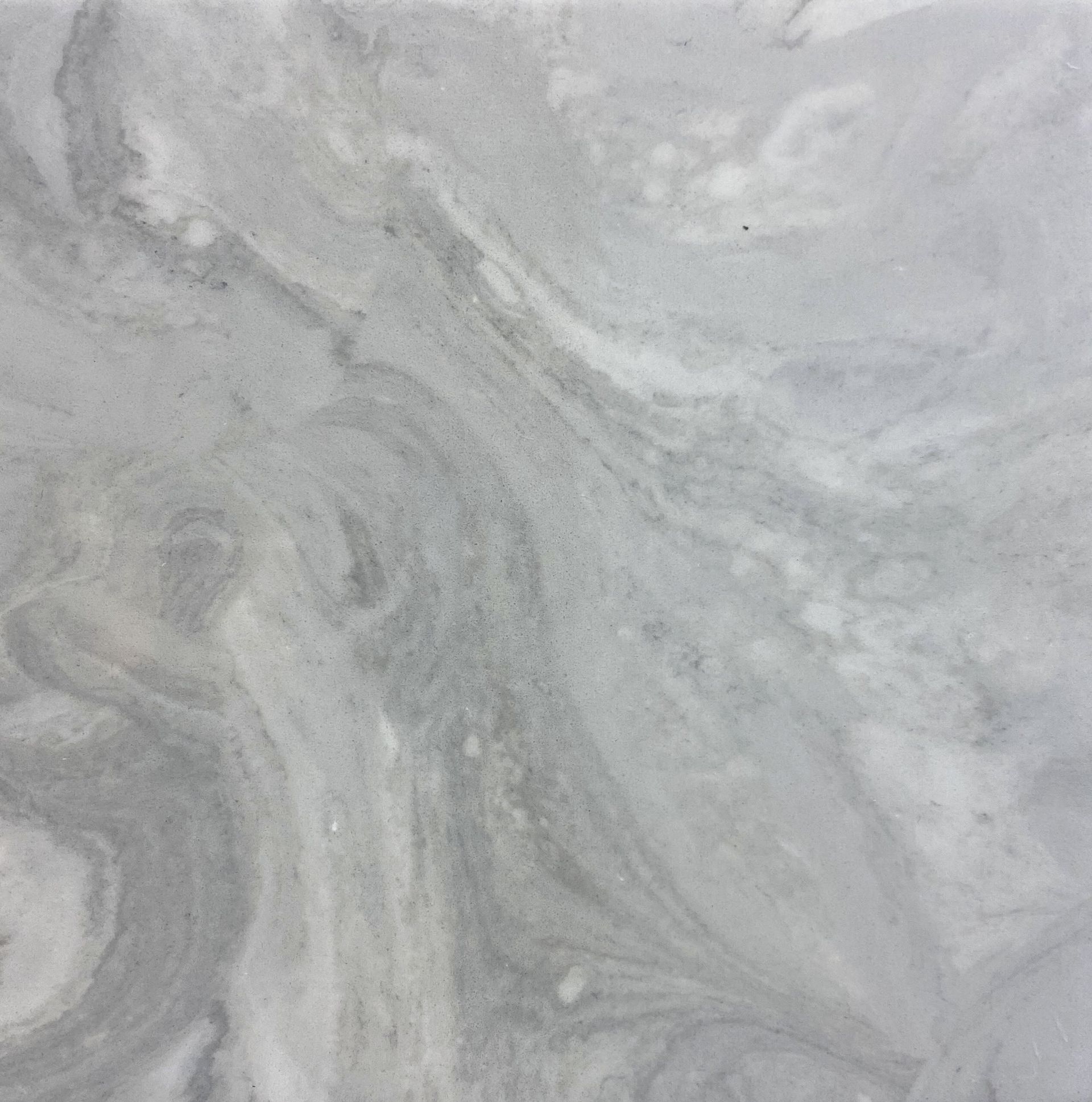 A close up of a marble tile with a swirl pattern.