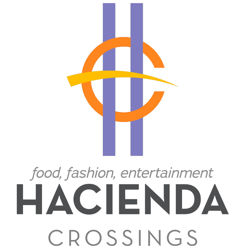 The hacienda crossings logo is purple and orange