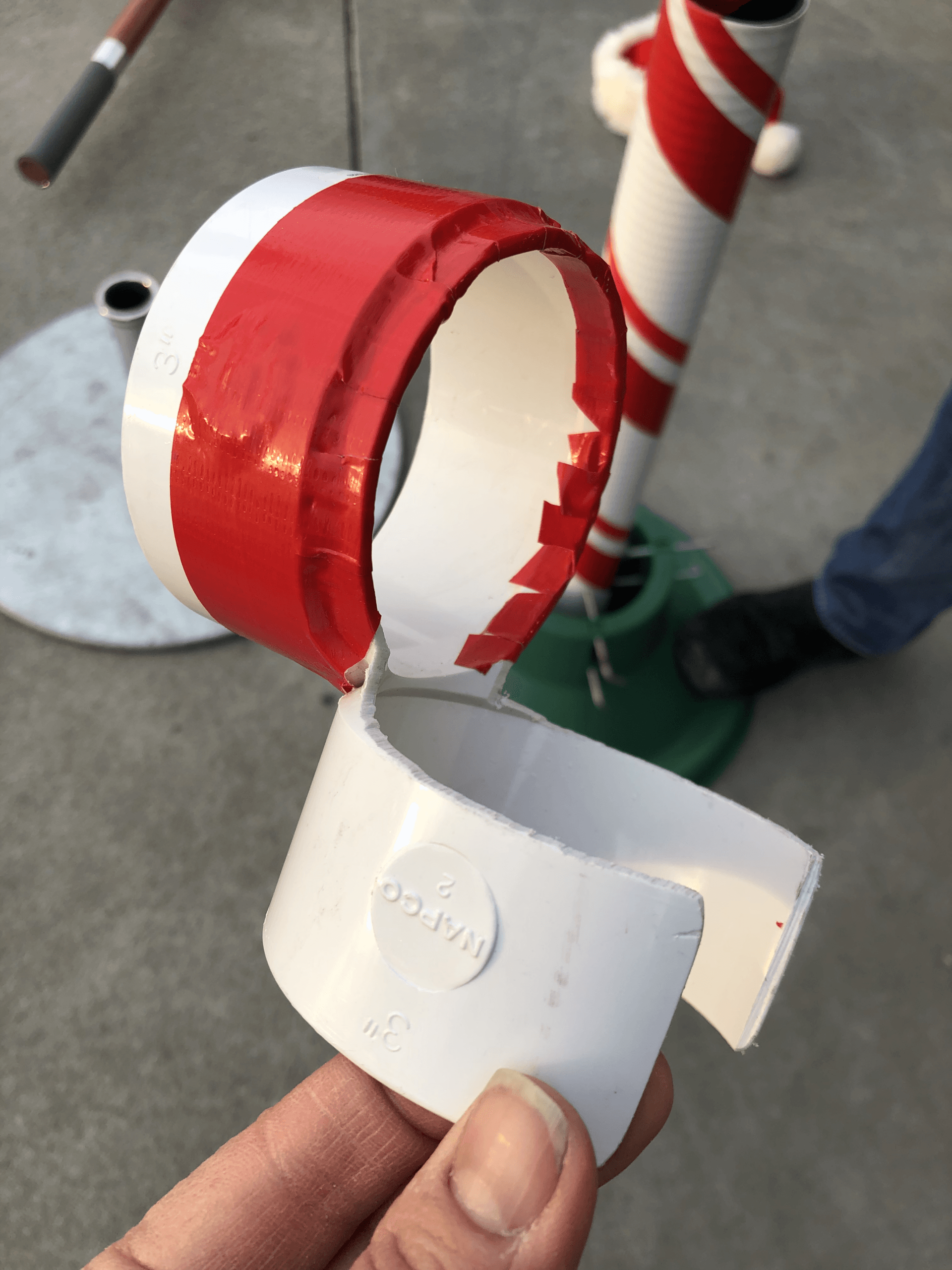 A person is holding a piece of plastic that says pvc on it