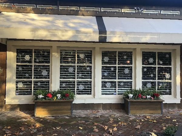A row of windows with snowflakes painted on them
