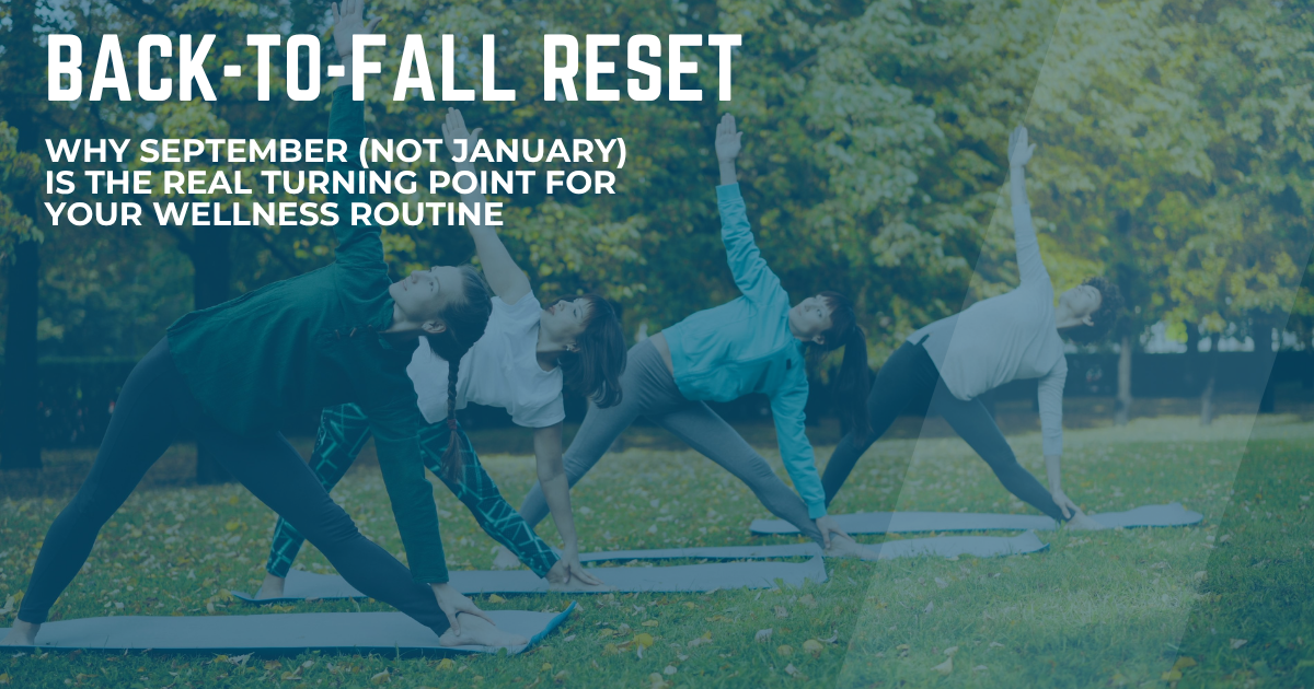 Group practicing outdoor yoga triangle pose among fall foliage