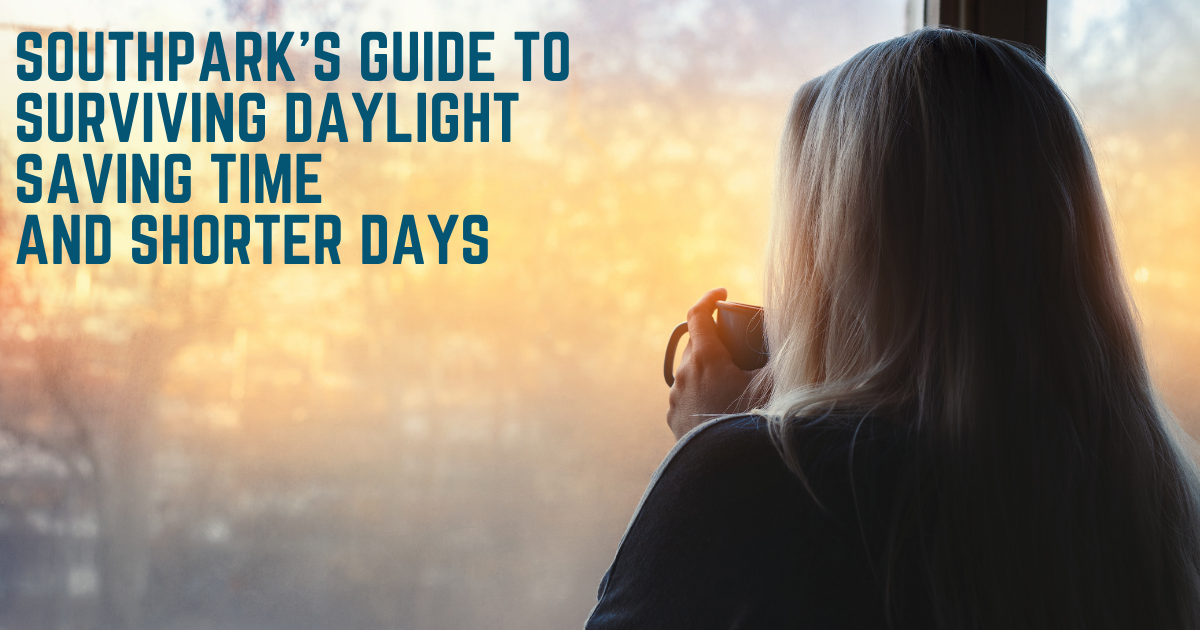 Woman holding a mug of coffee and looking out a window at the morning sunrise