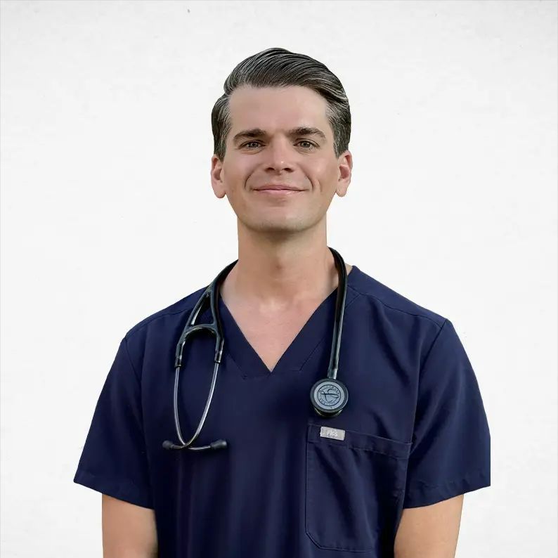 A man in a blue scrub top with a stethoscope around his neck