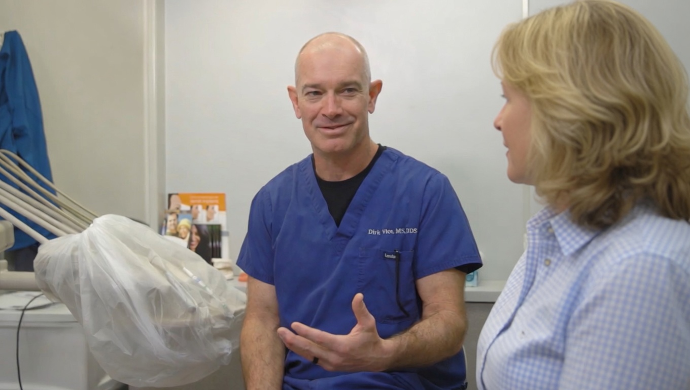Dr. Vice discussing Therapeutic Botox in Raleigh, NC, with a patient seated nearby.