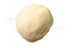 Pallina di pasta rotonda di colore giallo pallido su sfondo bianco.