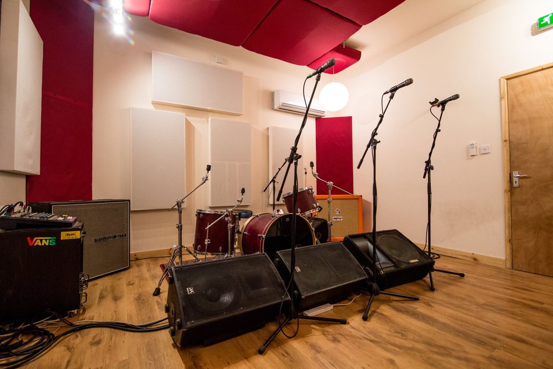 A view of the live room set up for a rehearsal session at new cut studios - with drums, bass and guitar