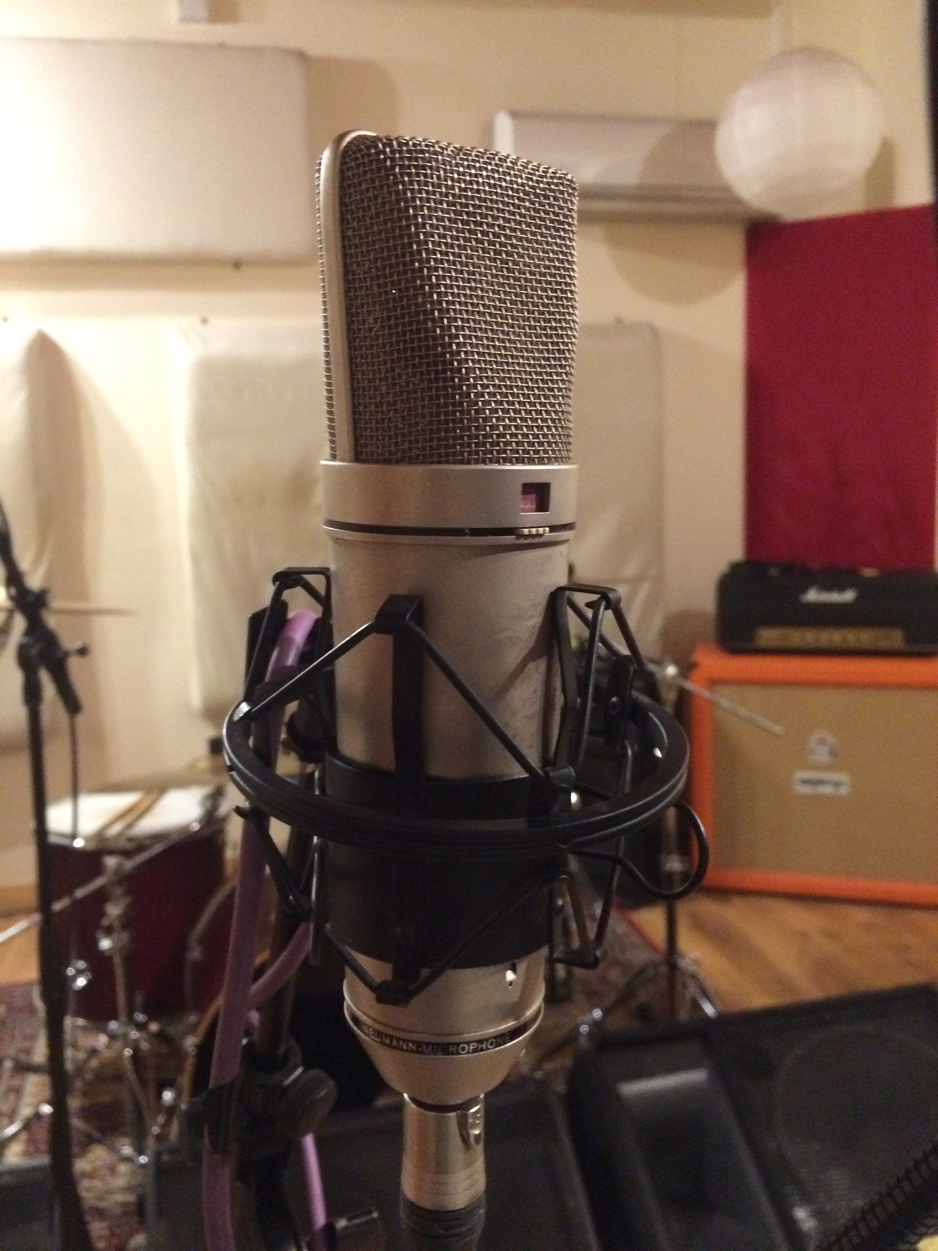Neumann u87 p48 set up to capture the room during a live performance