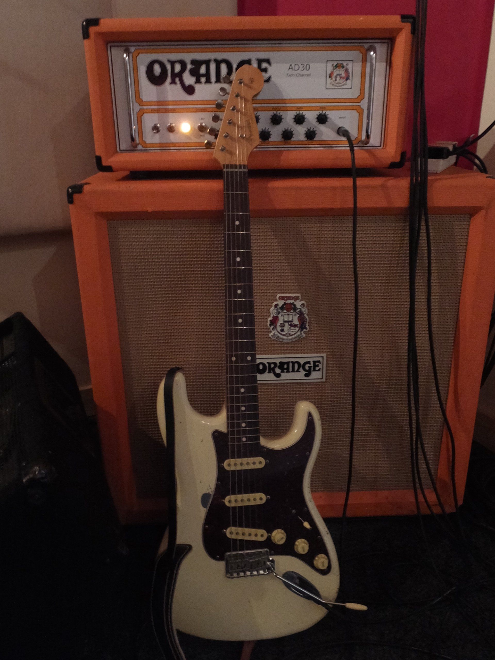 The Olympic White Strat I made may not be a lefty, but it's propped against an Orange Relic 61 Stratocaster and Orange amp