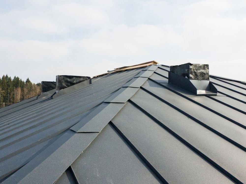 A View of a Brick House With a grey Roof — Coastal Roofing Professionals In Chinderah, NSW