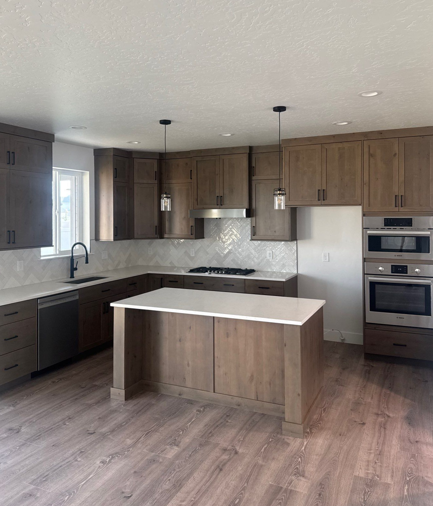 A kitchen with wooden cabinets and stainless steel appliances.