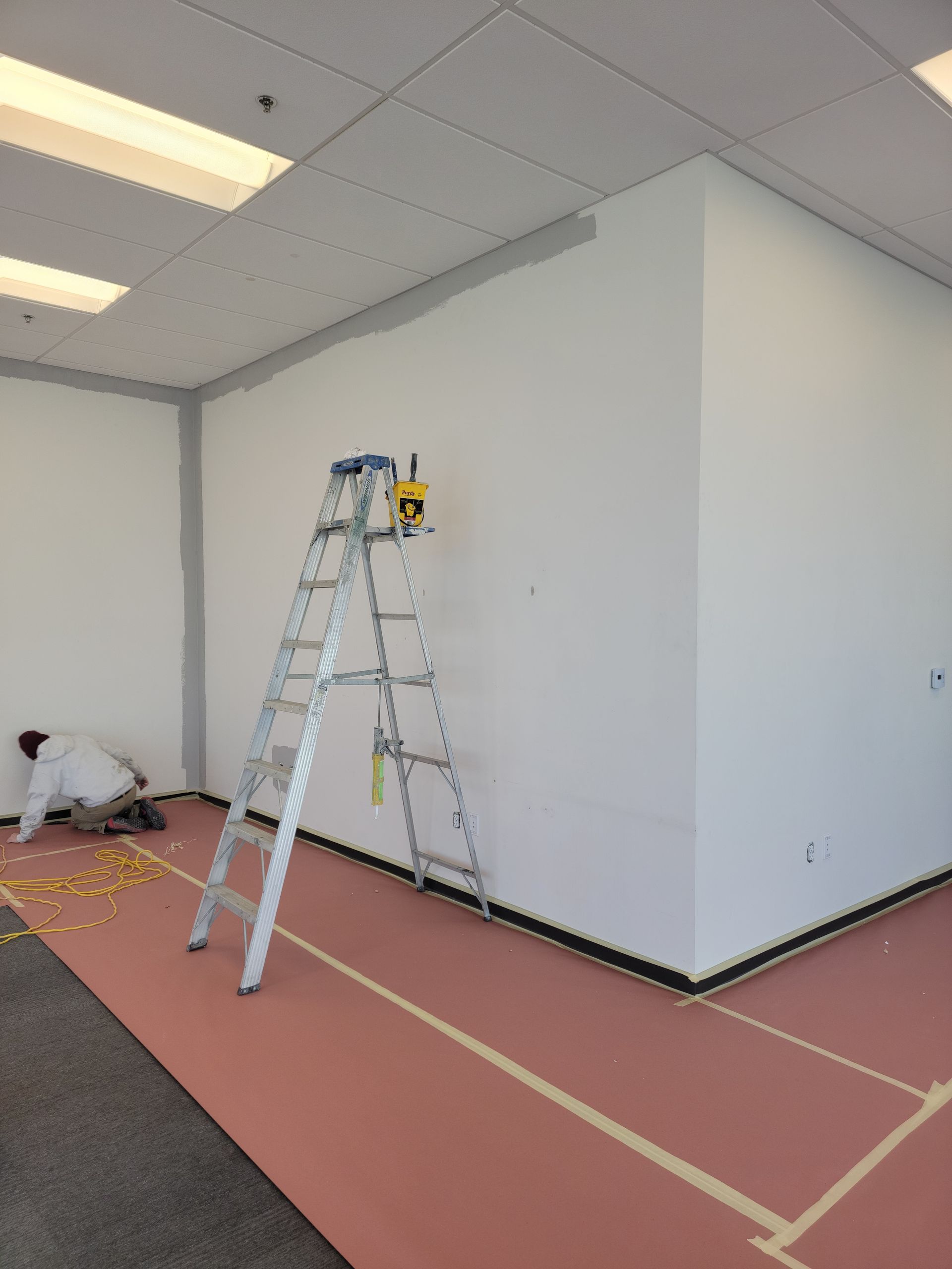 A ladder is leaning against a wall in a room