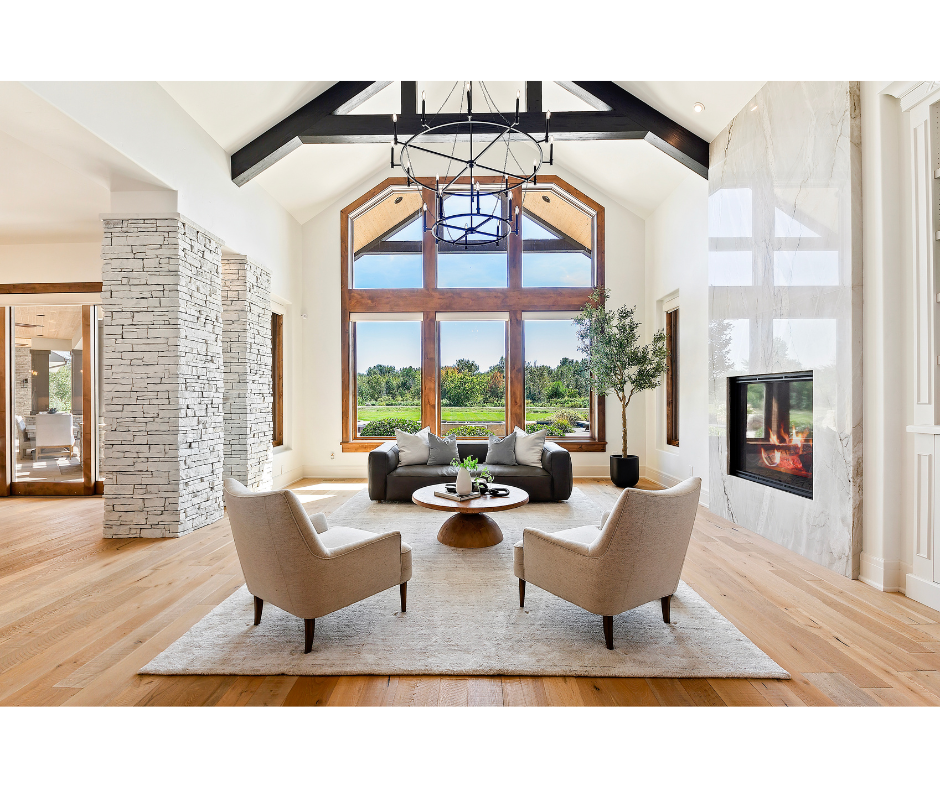 A living room with two chairs , a coffee table , and a fireplace.