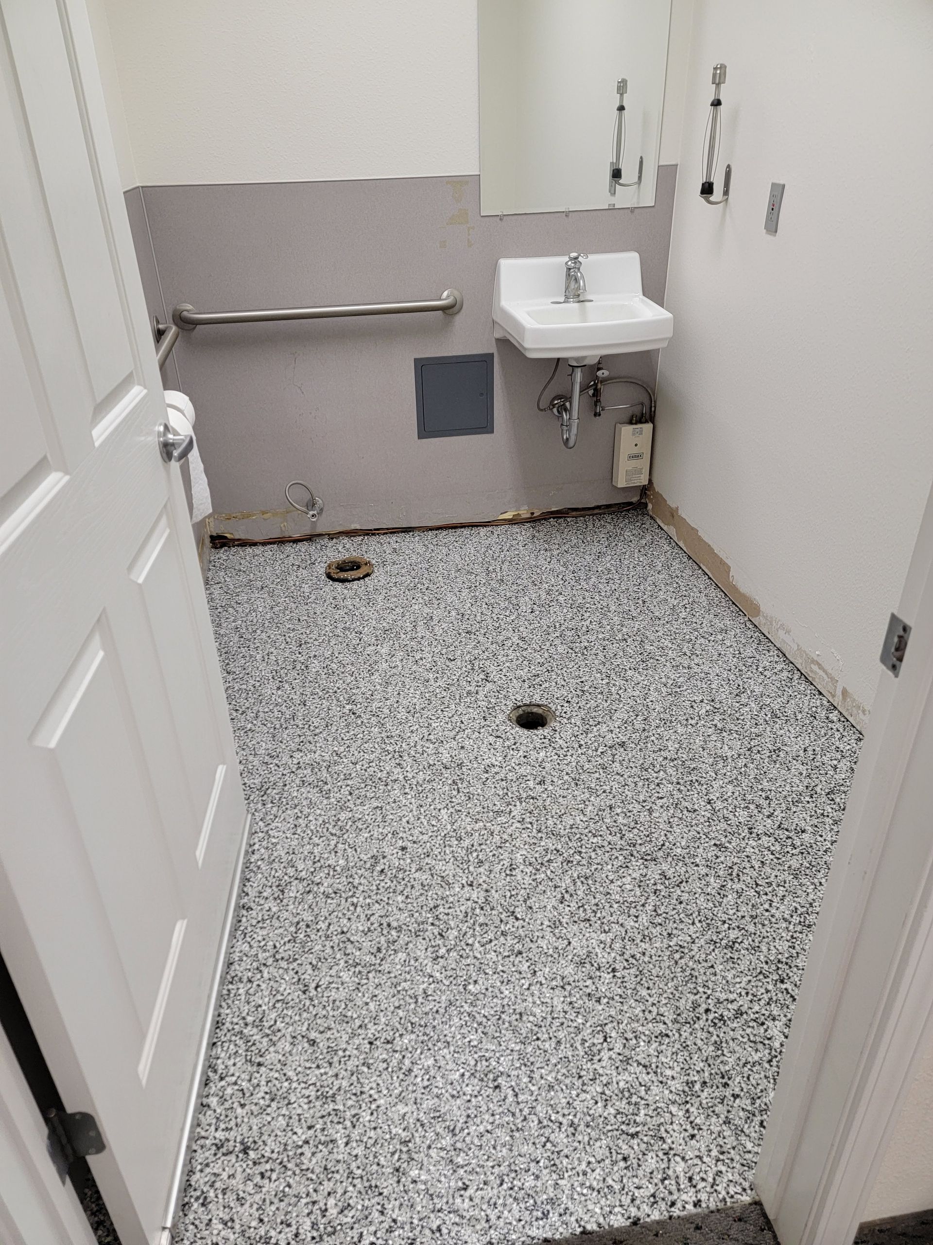 A bathroom with a sink and a door leading to it.
