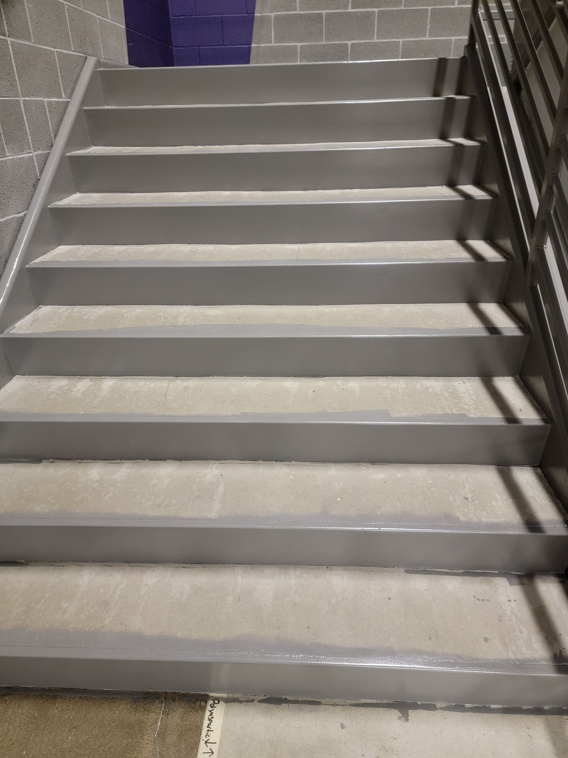 A set of stairs leading up to a brick wall.
