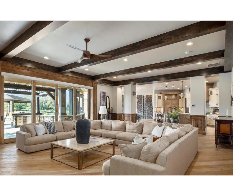 A living room with a lot of furniture and a ceiling fan.