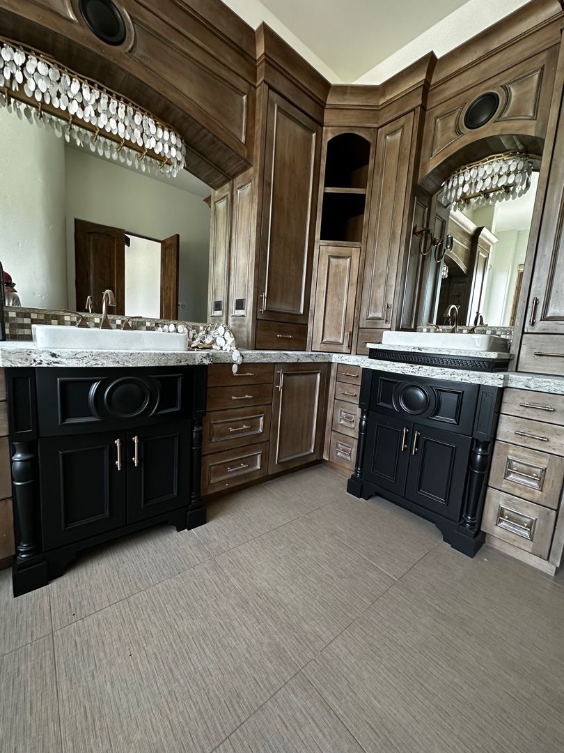 A bathroom with two sinks and a large mirror.
