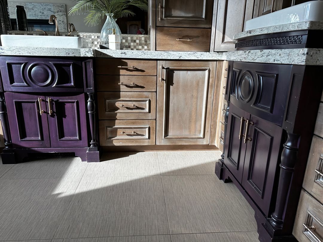 A kitchen with purple cabinets and a sink
