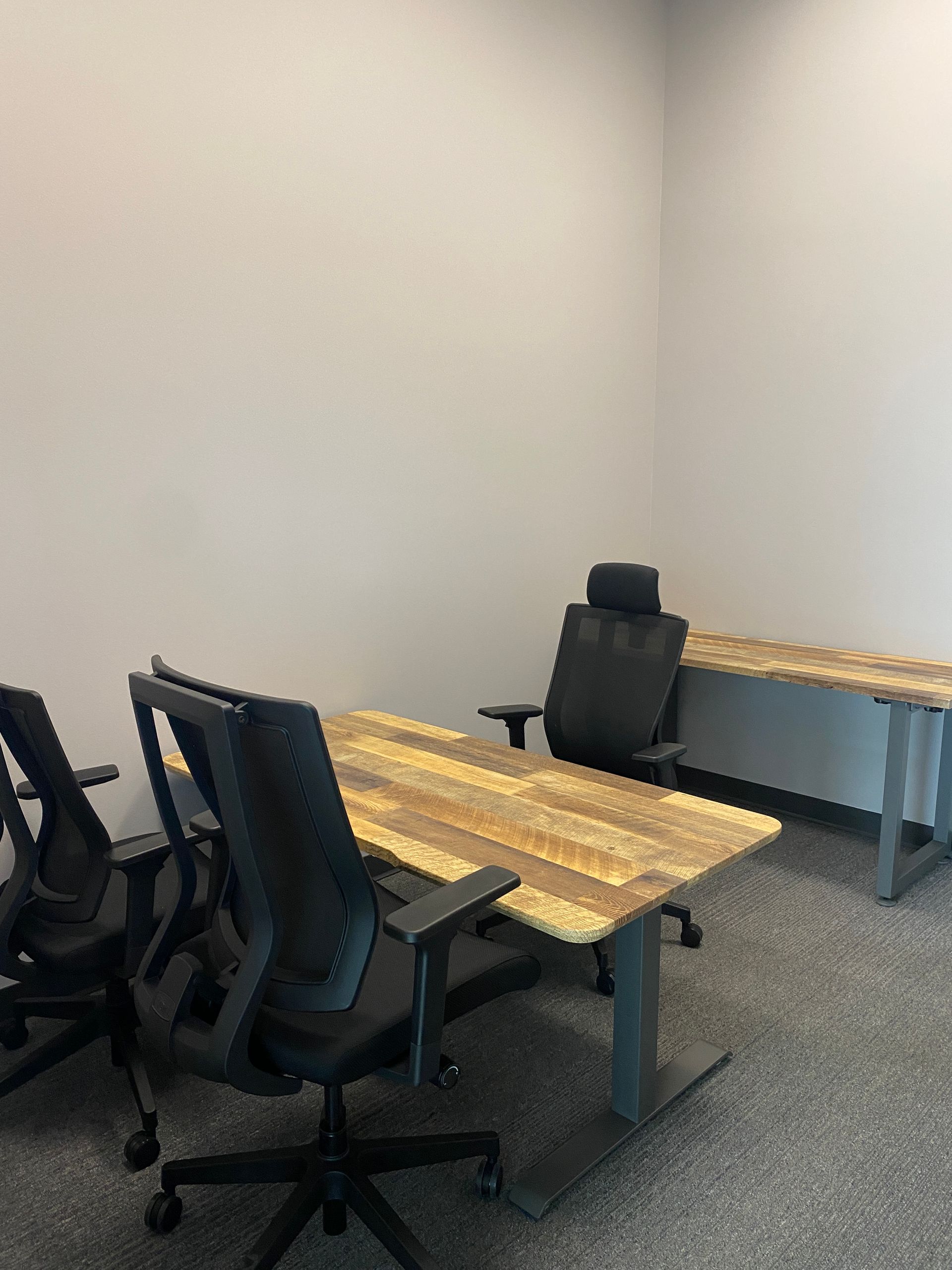 A room with two tables and chairs in it.