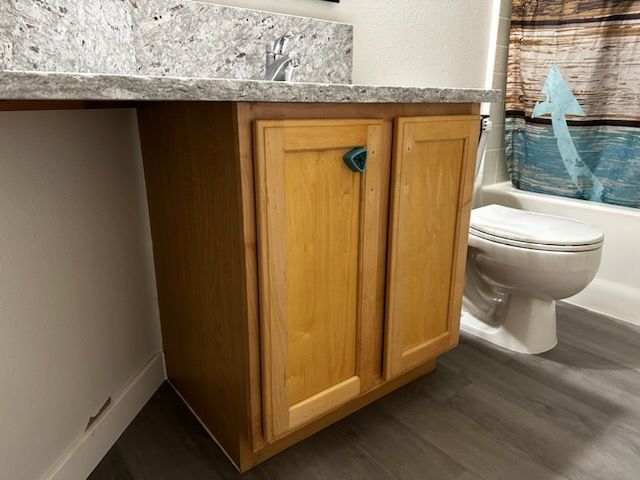A bathroom with a sink , toilet and bathtub.