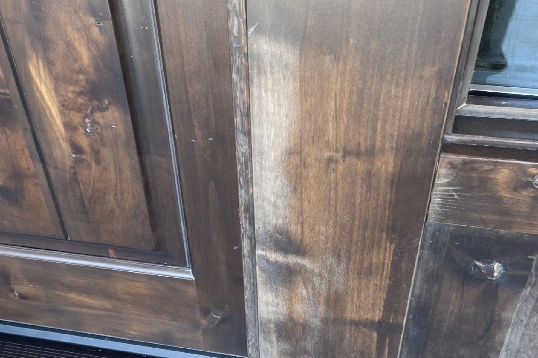 A close up of a wooden door with a stain on it