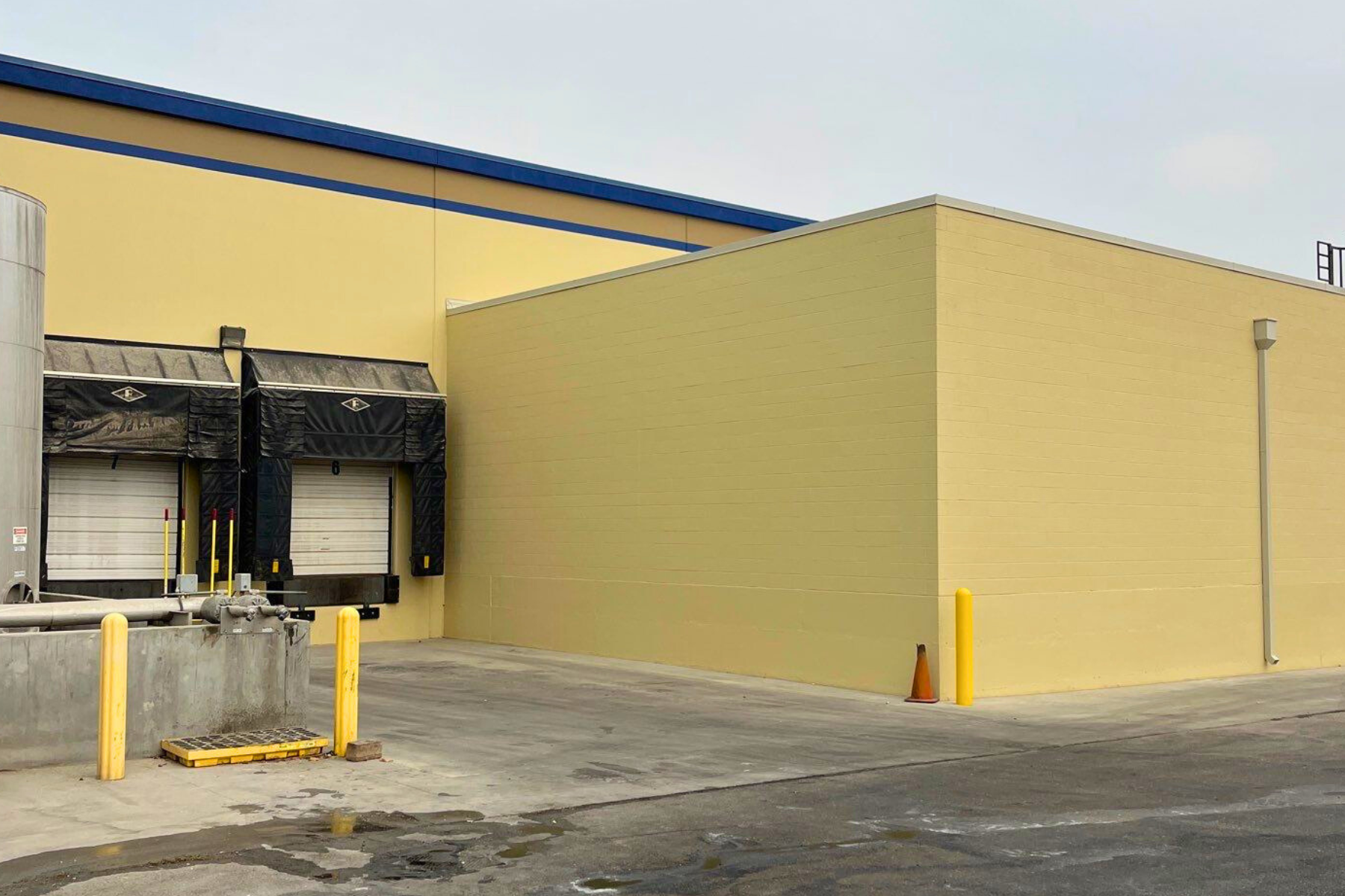 A yellow building with a loading dock on the side of it.