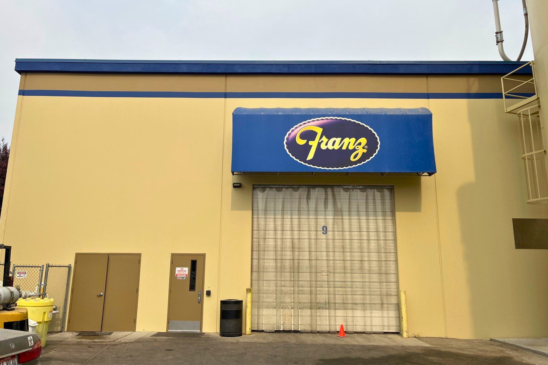 A yellow building with a blue awning that says franz