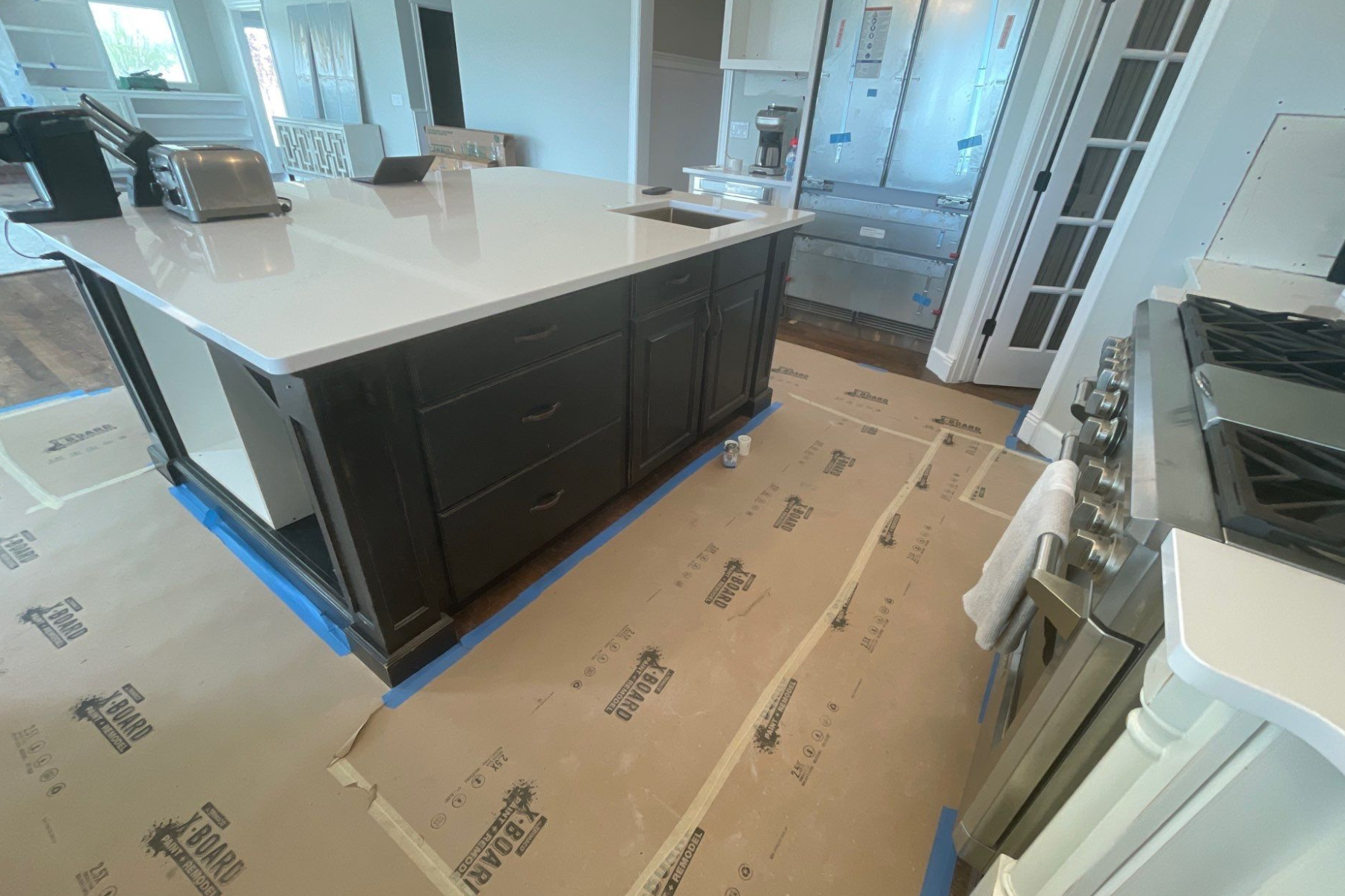 A kitchen with a large island and a stove.