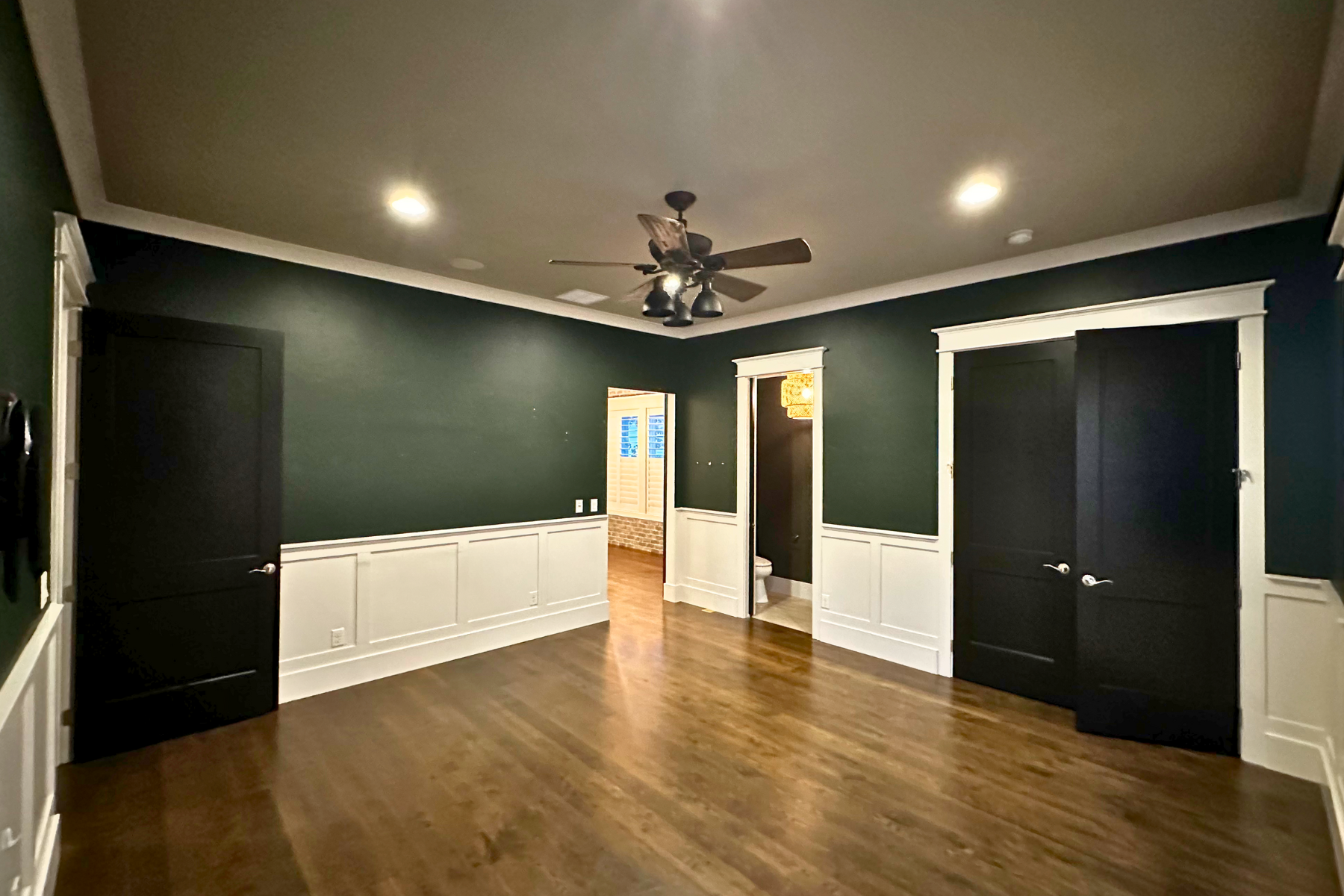 There is a ceiling fan in the middle of the room.