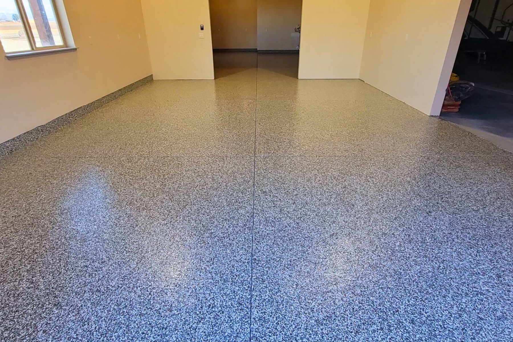 A room with a concrete floor and a window.