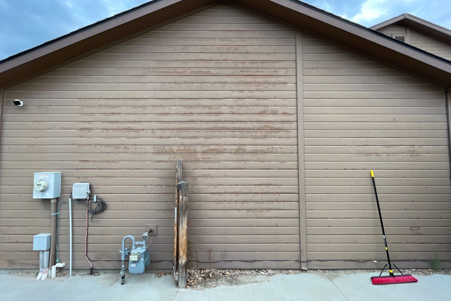 A house with a broom on the side of it