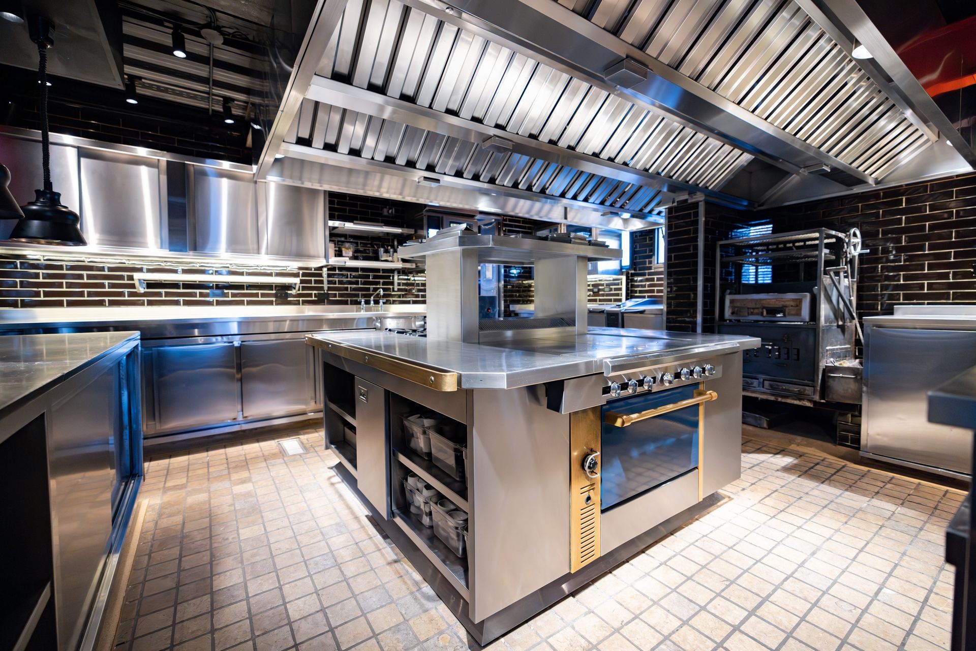 Wide shot of empty industrial kitchen with stainless counters. Wide shot of empty industrial kitchen with stainless counters.