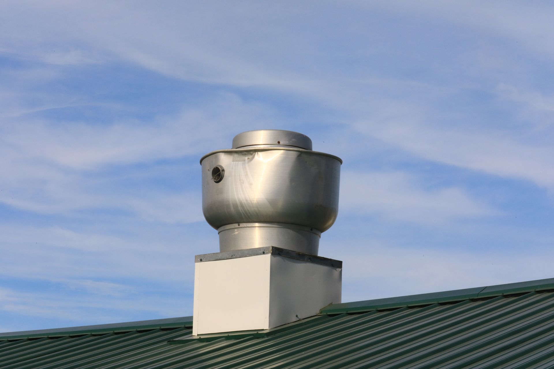 Exhaust fan mounted in commercial kitchen ceiling.