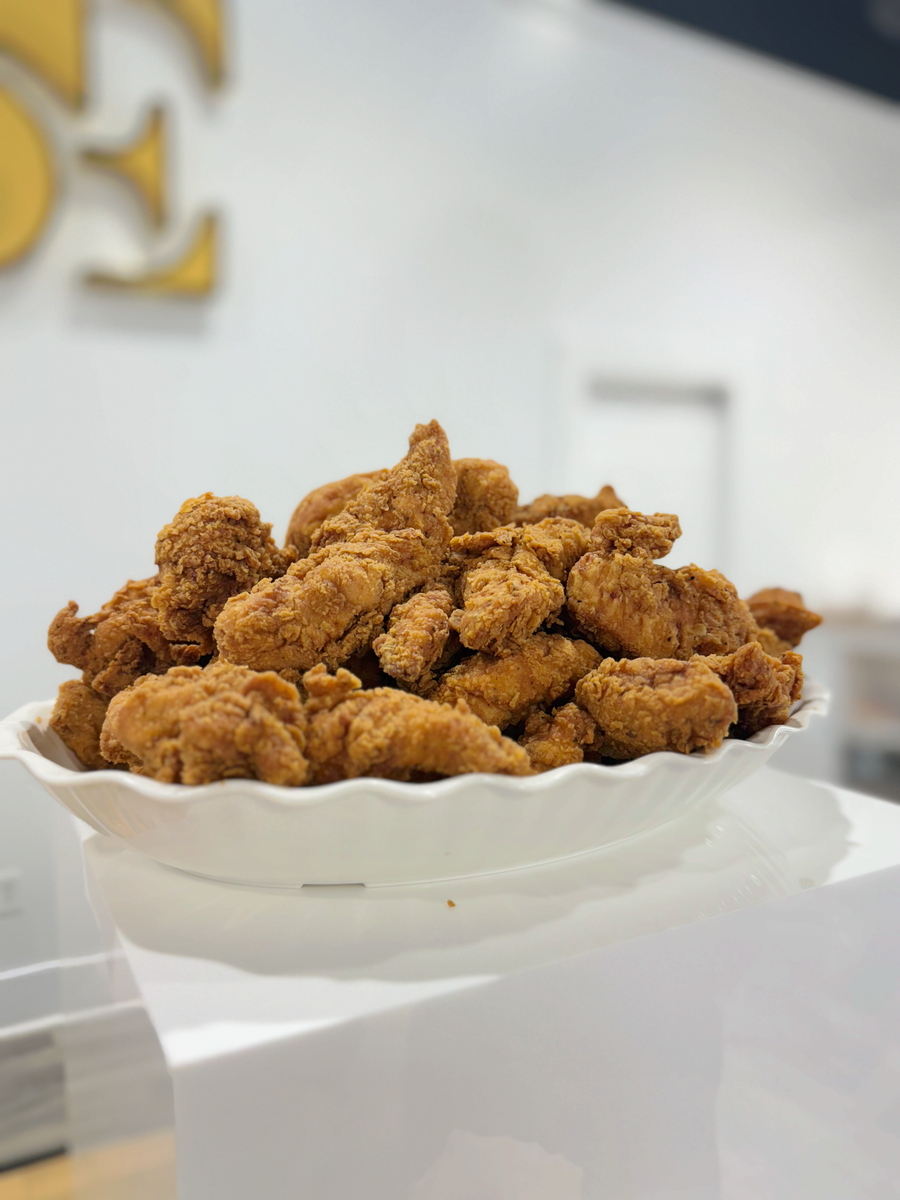 White bowl piled with golden-brown breaded fried pieces on a table