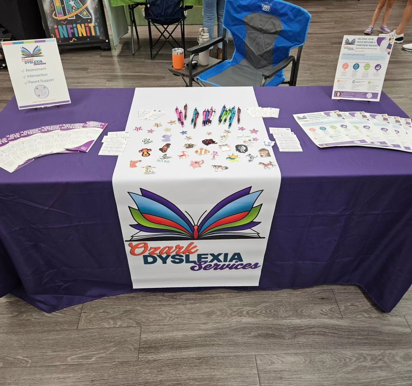 Accessibility booth with purple tablecloth, Oklahoma Dyslexia Association banner, and brochures on display