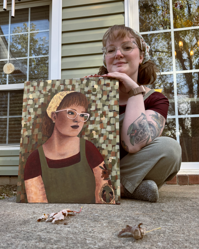 Person crouches beside a painted portrait on a porch, with small figurines in the foreground.