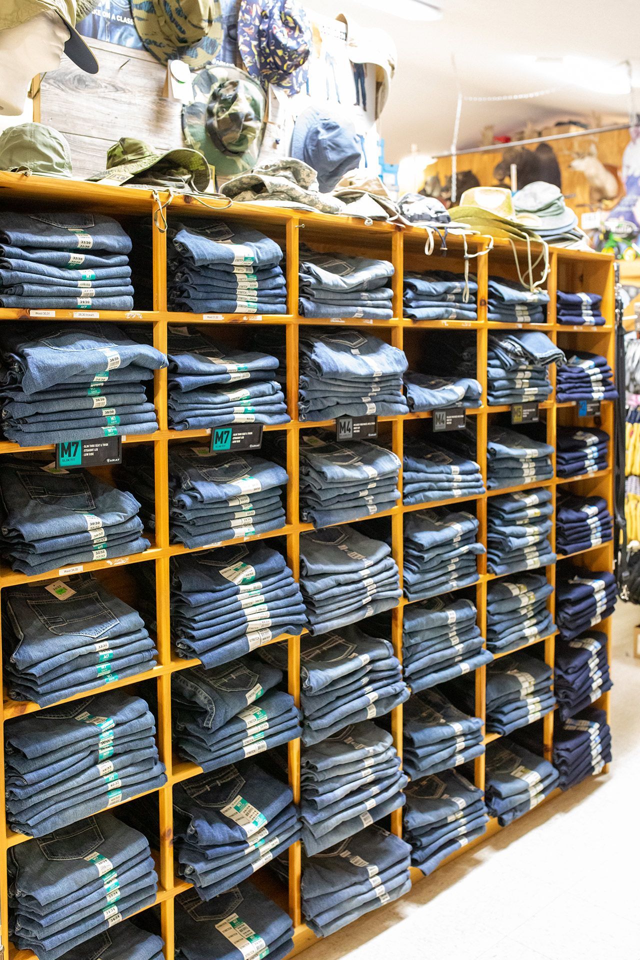 Shelves packed with folded jeans in a clothing store stockroom