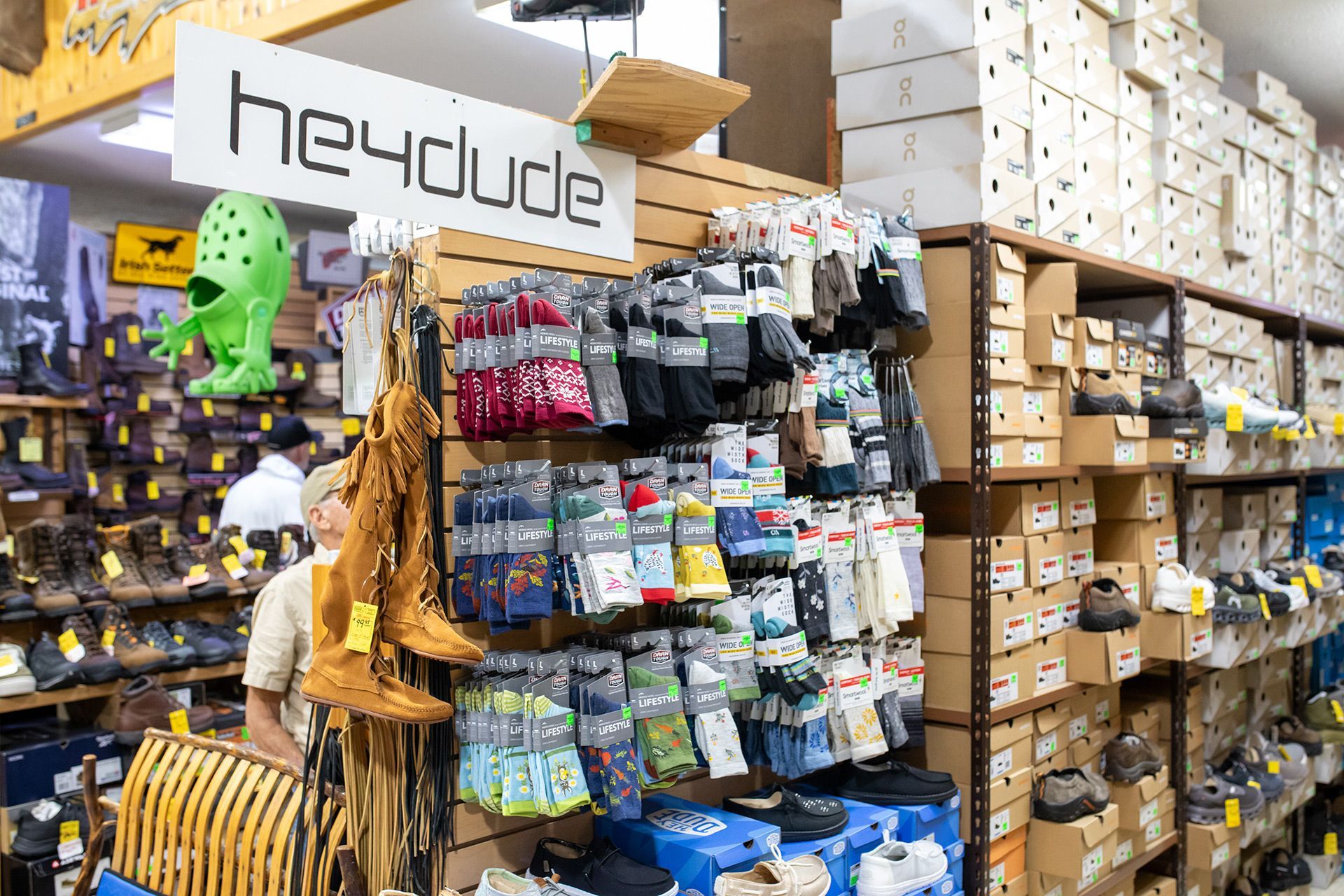 Hardware store aisle with tools, supplies, and hanging packaged goods on shelves