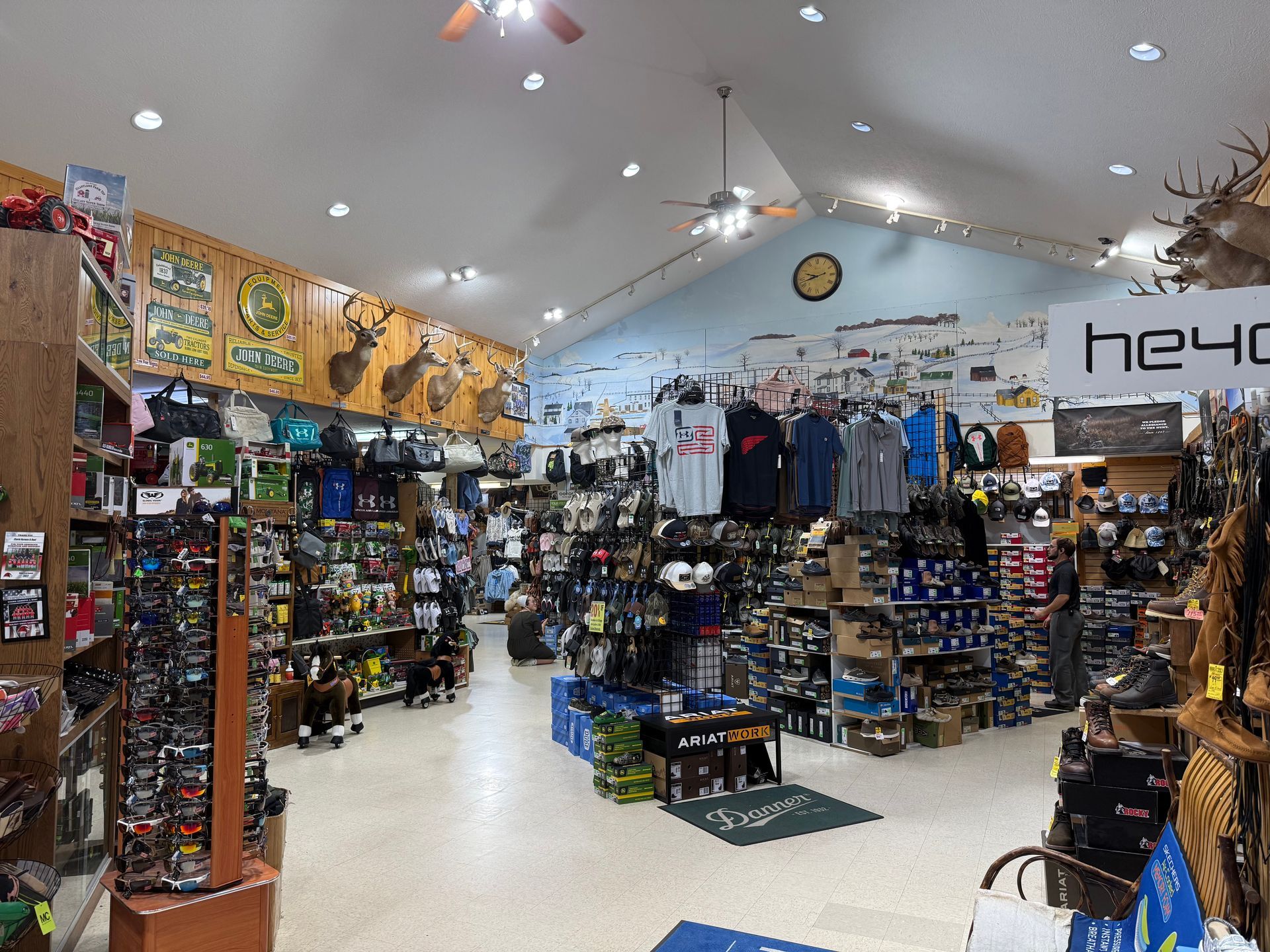 Brightly lit surf and skate shop interior with shelves of merchandise and clothing displays