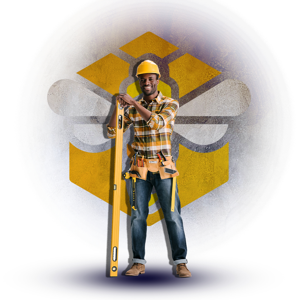 Construction worker in plaid shirt and hard hat holding a measuring tool, standing before a yellow geometric logo.