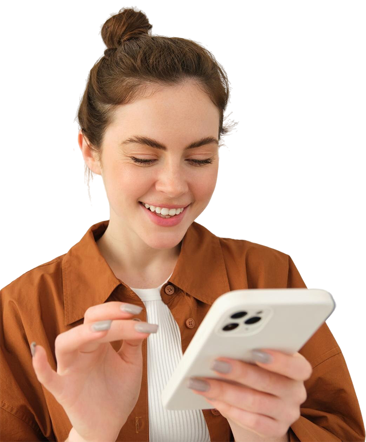 Woman smiling, looking at a smartphone, wearing a brown shirt and bun hairstyle.