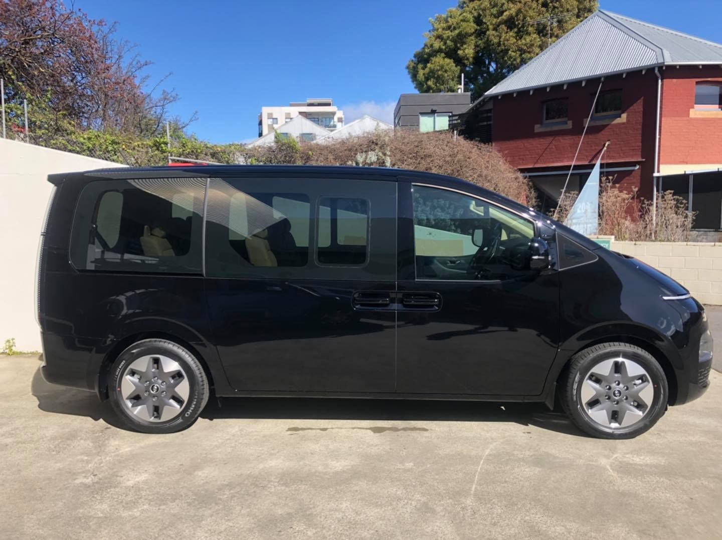 A Black Minivan Parked on a Concrete Surface — Magic Tintz in Moonah, TAS