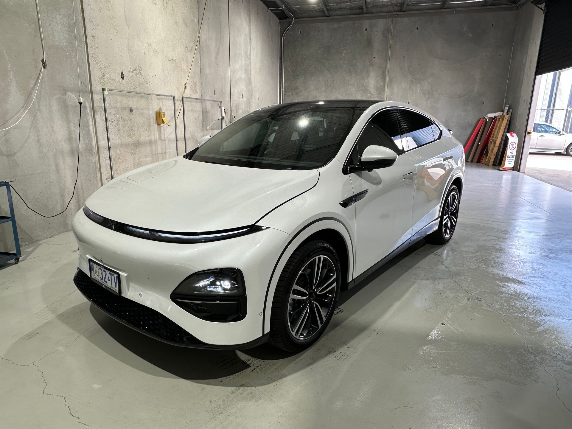 White electric crossover SUV parked  a concrete garage, front-left view — Magic Tintz in Moonah, TAS