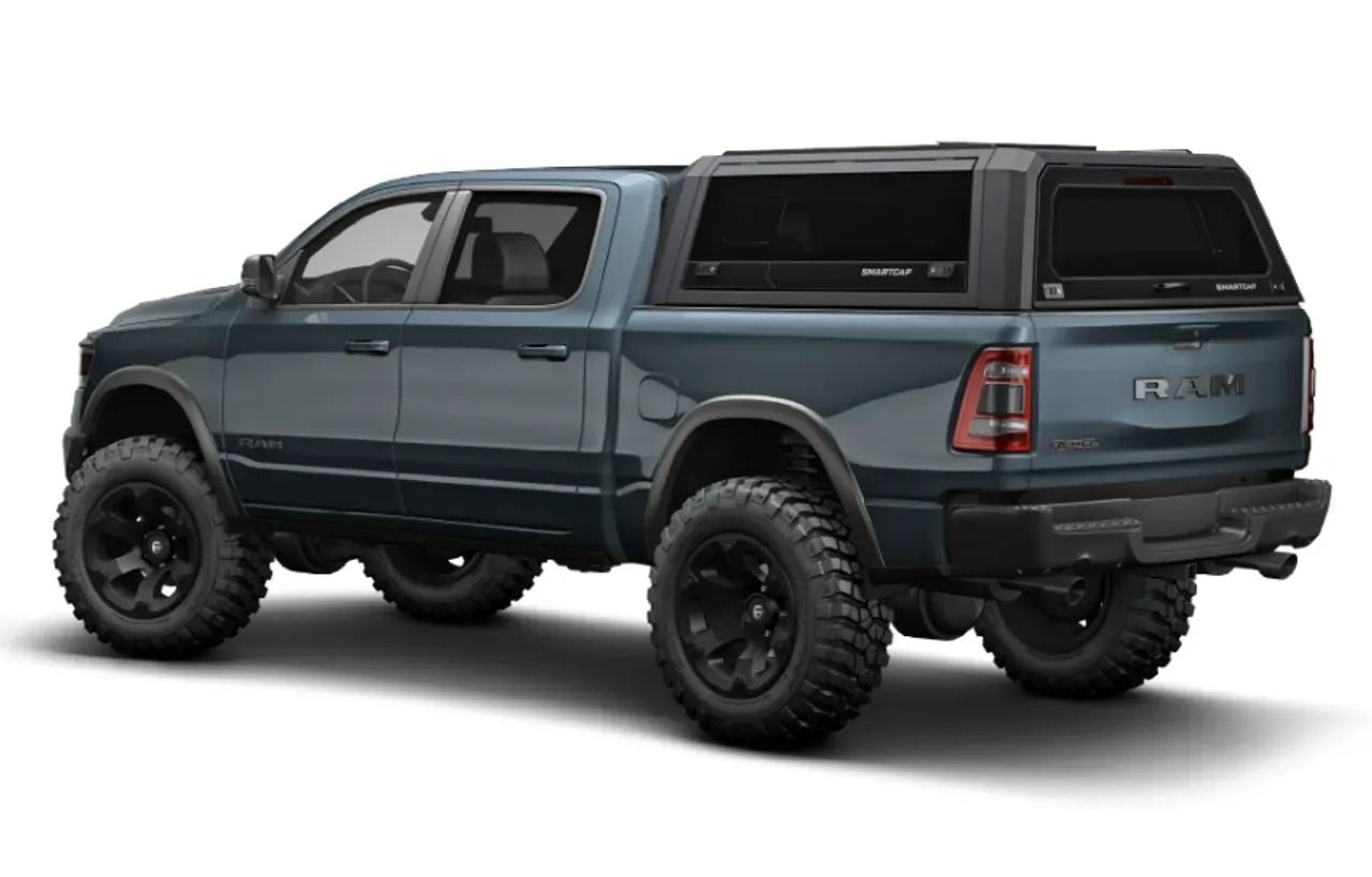 A blue ram truck with a canopy on top of it on a white background.
