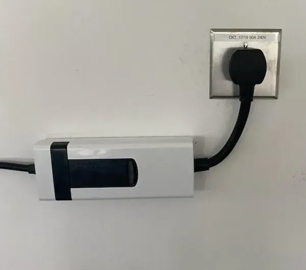 MJS Electrical Services - A plug is plugged into a wall outlet.