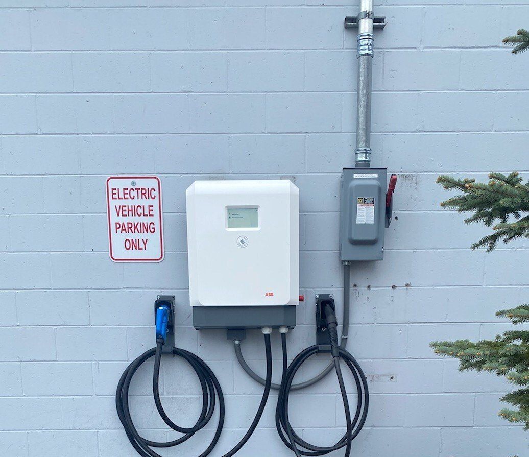 MJS Electrical Services - An electric vehicle charging station on the side of a building