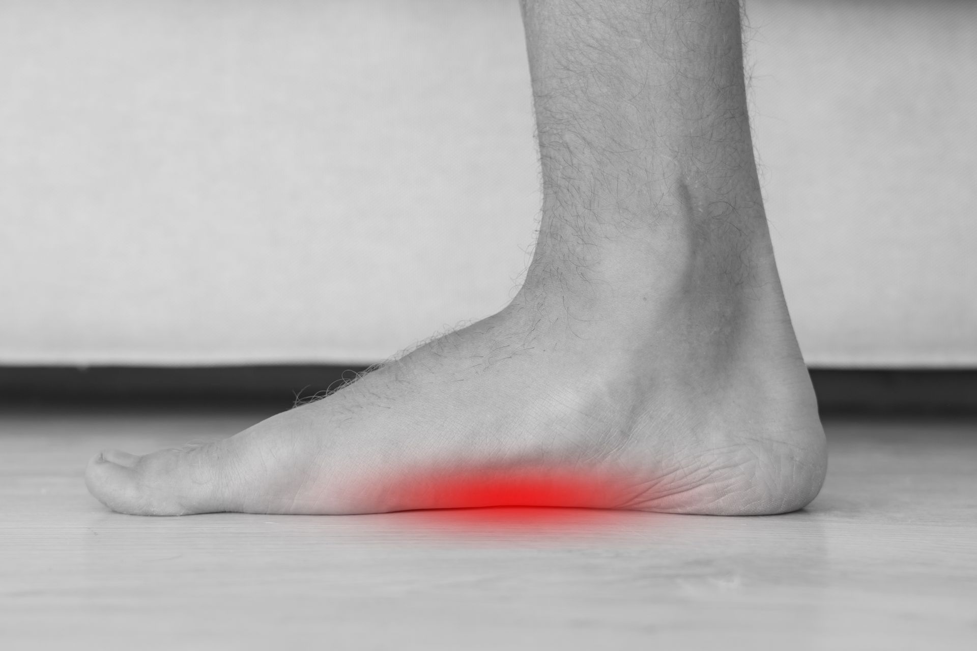 Foot with flat arch, highlighted red for pain.